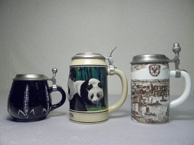 Three porcelain & pewter beer steins.