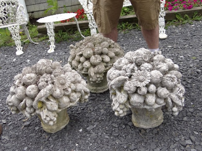Lot three cement floral urns. 17''