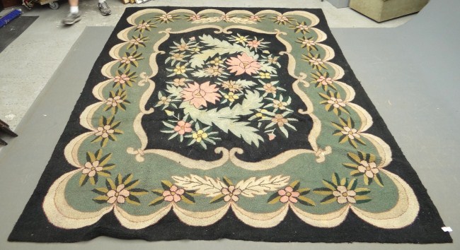 Roomsize floral hooked rug. 7'
