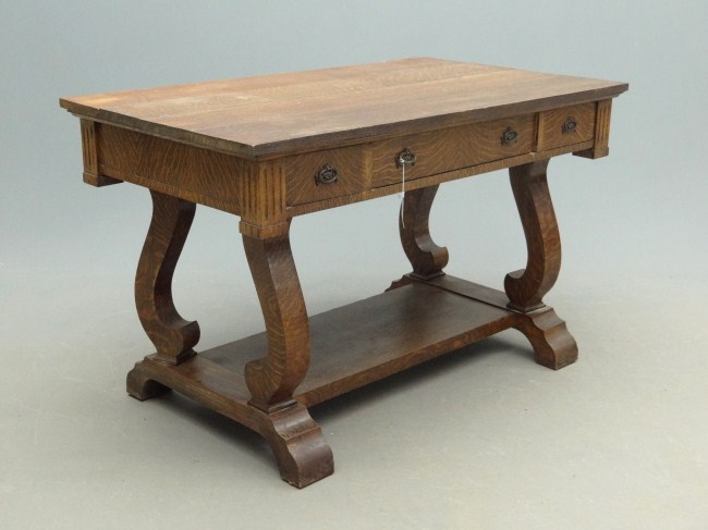 C. 1920s oak three drawer desk. Top