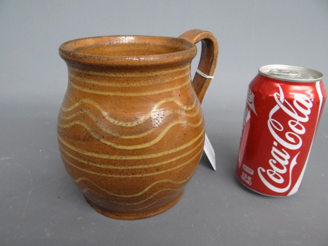 Redware slip decorated jug. 5 3/4''