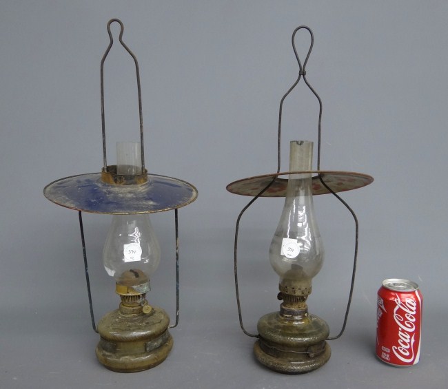 Lot (2) early glass and tin store lamps.