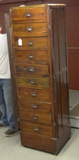 Tall chest of drawers with side mounts.