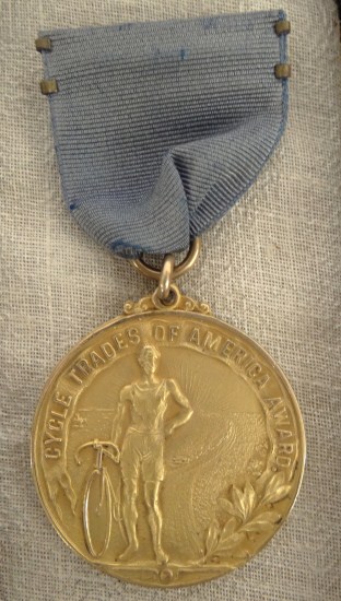 Gold filled medal with ribbon.