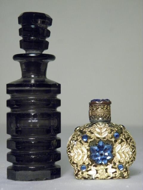 Two small perfume bottles. One is amethyst