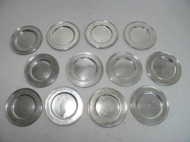 Twelve small sterling silver plates.