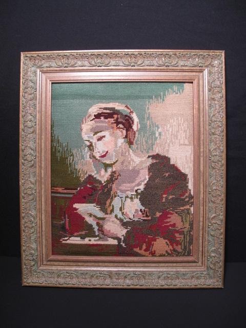 Framed needlepoint depicting woman