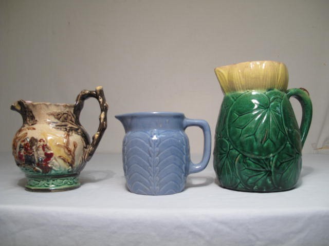 Three Majolica pottery pitchers.