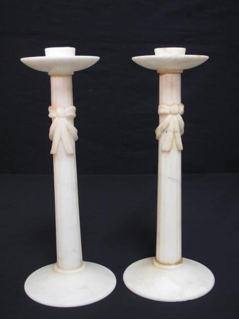 A pair of carved alabaster candlesticks