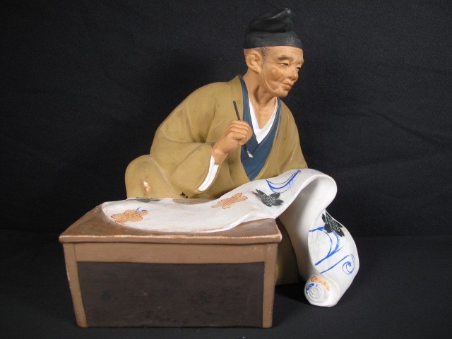Japanese slip cast figure of a man writing