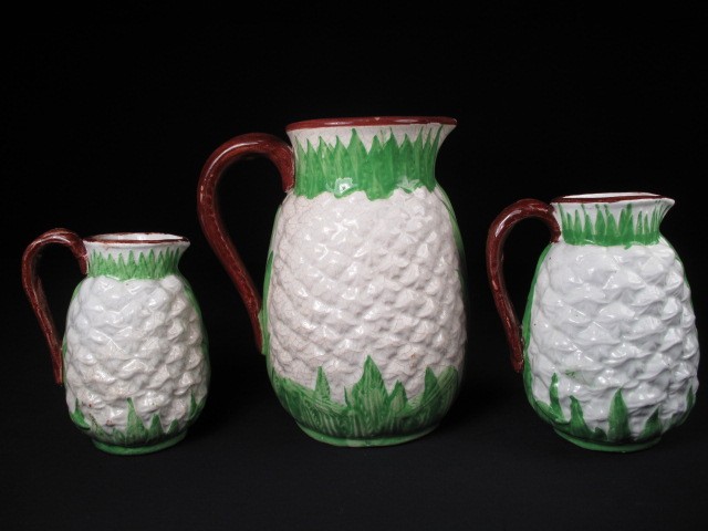 Three Majolica pottery pitchers graduated