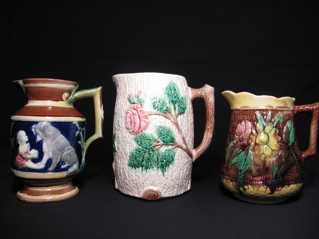 Lot of three Majolica pottery pitchers.