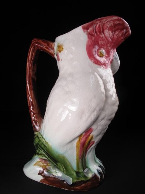 A Majolica pottery pitcher with parrot