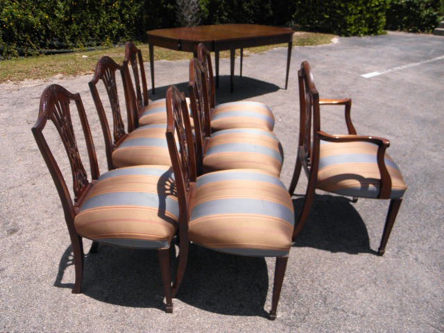 Seven carved Mahogany dining chairs.