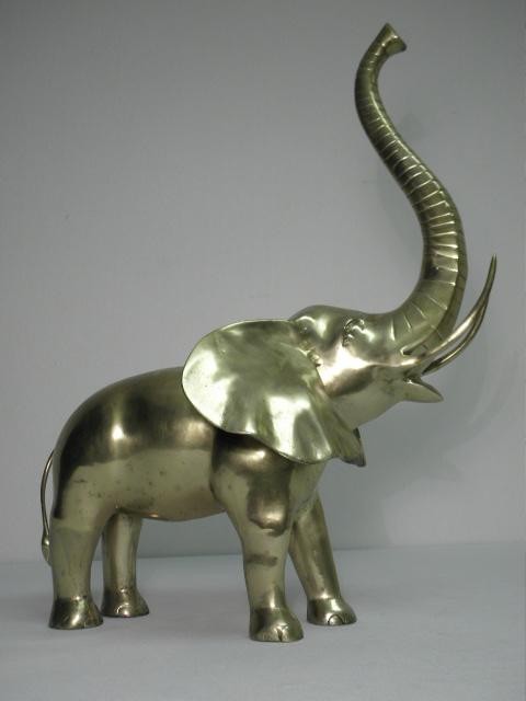 Polished brass sculpture of an elephant.