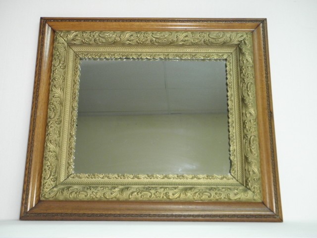 Carved oak wall mirror with a gilt