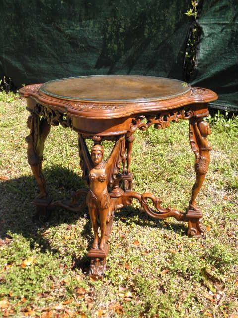 Glass top carved mahogany figural