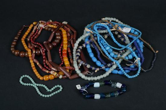 15 GLASS AND CERAMIC BEAD STRANDS.