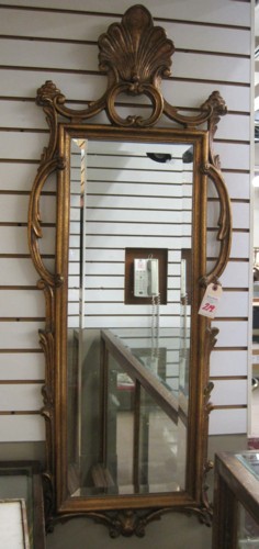 A DECORATOR'S BEVELED WALL MIRROR