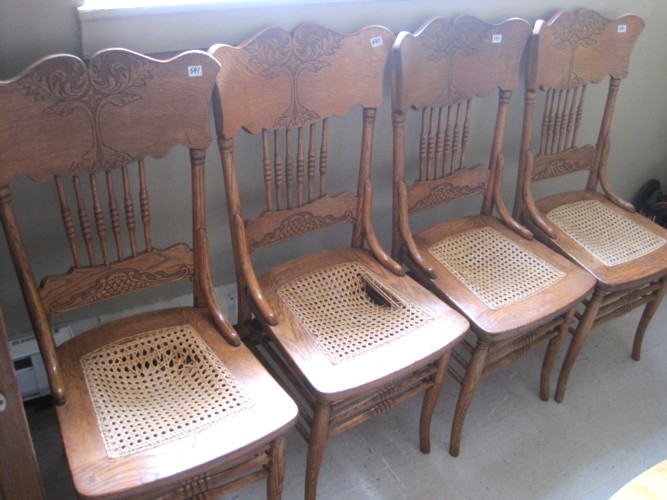 A SET OF FOUR OAK PRESSED-BACK DINING