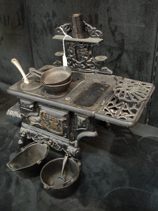 A CRESCENT CAST IRON TOY STOVE with