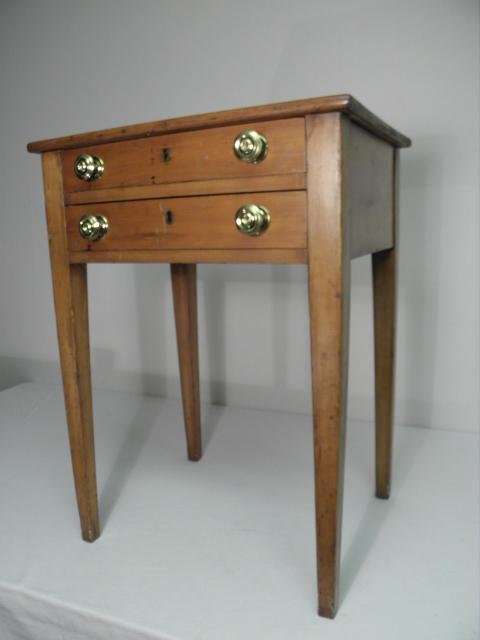 A small maple two-drawer side table