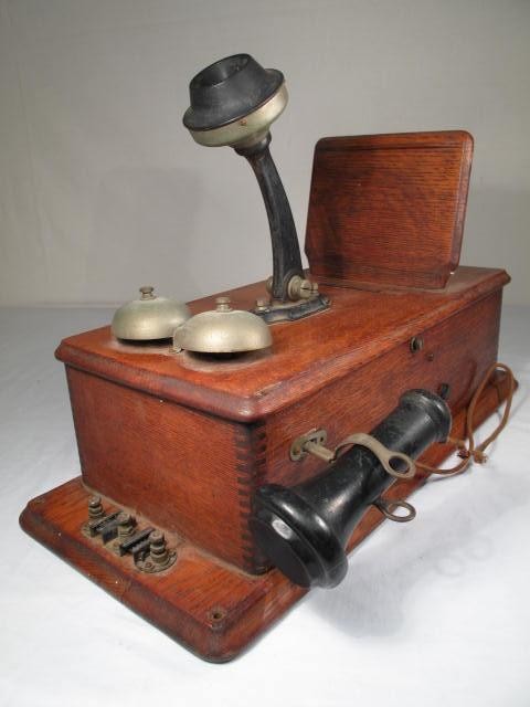 Two antique wall telephones. One