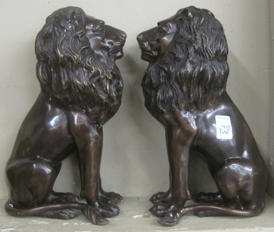 PAIR OF BRONZE LIONS cast in matching