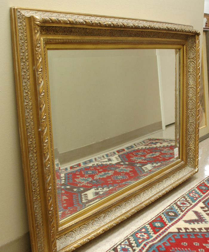 A GILT WOOD AND GESSO BEVELED WALL