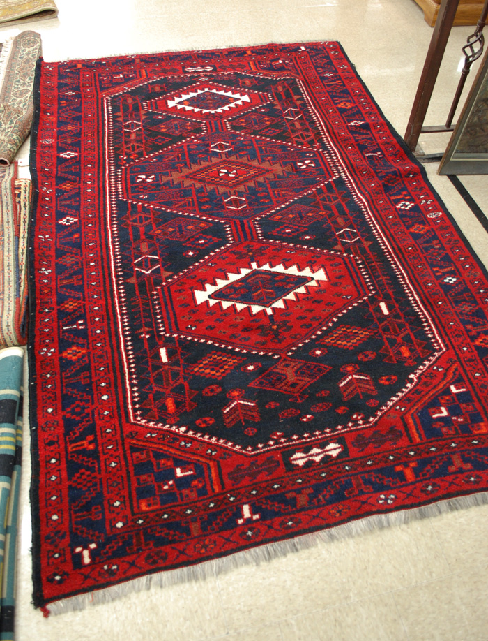 AN AFGHAN BELOUCH CARPET featuring