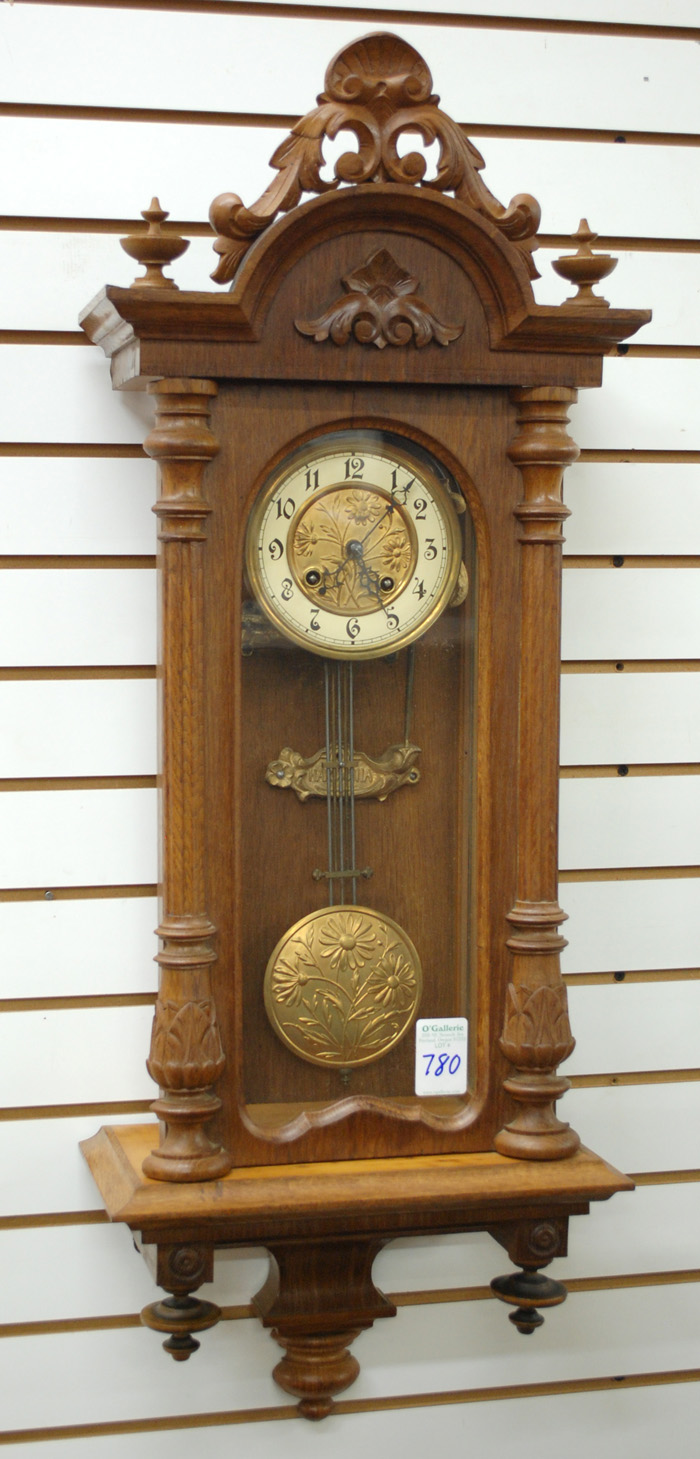 AN OAK AND GLASS CASED WALL CLOCK 16fa67
