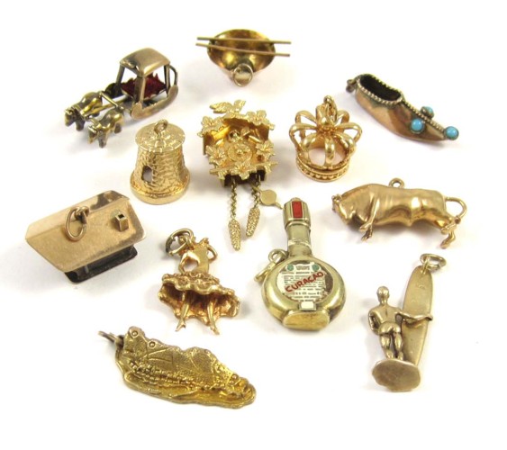 TWELVE YELLOW GOLD CHARMS including