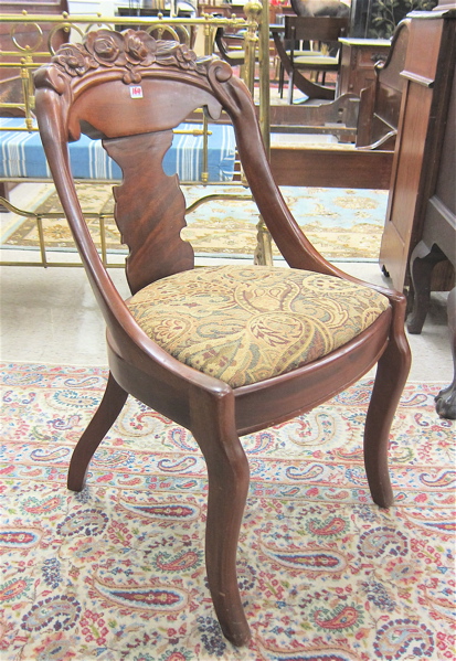 A SET OF FOUR CARVED MAHOGANY DINING