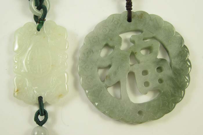 TWO CHINESE CARVED JADE PENDANTS: