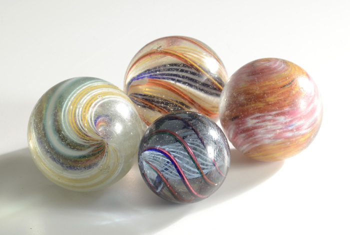 FOUR LARGE HAND MADE GLASS MARBLES: