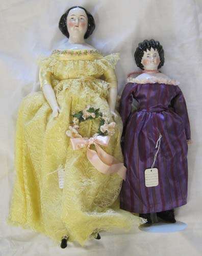 TWO CHINA SHOULDER-HEAD DOLLS each