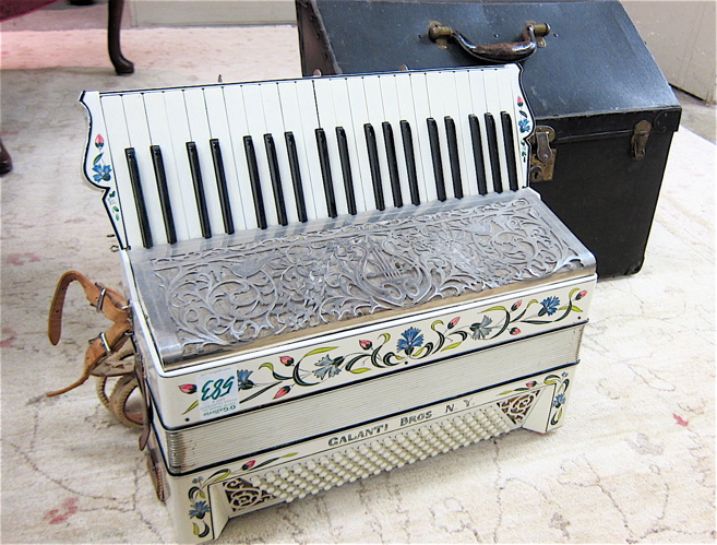 A VINTAGE ACCORDION WITH TRAVEL