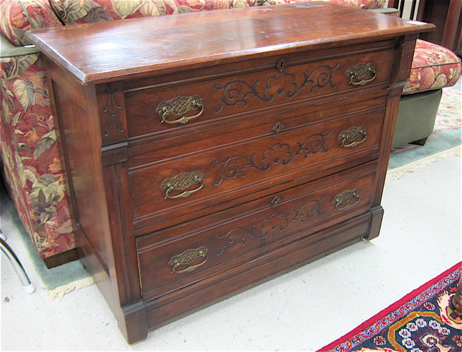 A VICTORIAN WALNUT CHEST OF DRAWERS