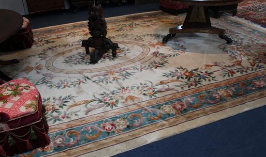 A Chinese ivory ground carpet decorated