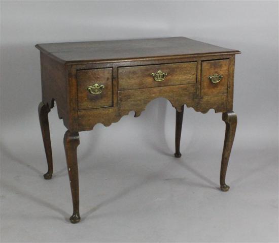 A George II oak lowboy with three