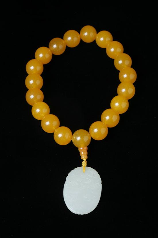 CHINESE YELLOW SOAPSTONE PRAYING