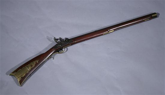 BRASS-MOUNTED ANTIQUE RIFLE. Statements