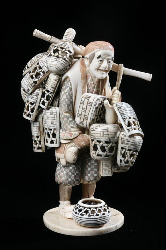 JAPANESE IVORY OKIMONO OF BASKET SELLER.