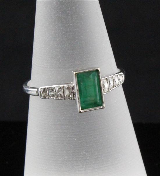 A platinum emerald and diamond