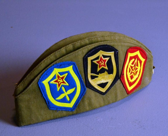 A Russian Military Hat And MedalsA