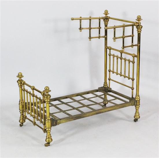 A Victorian brass doll's bed maker