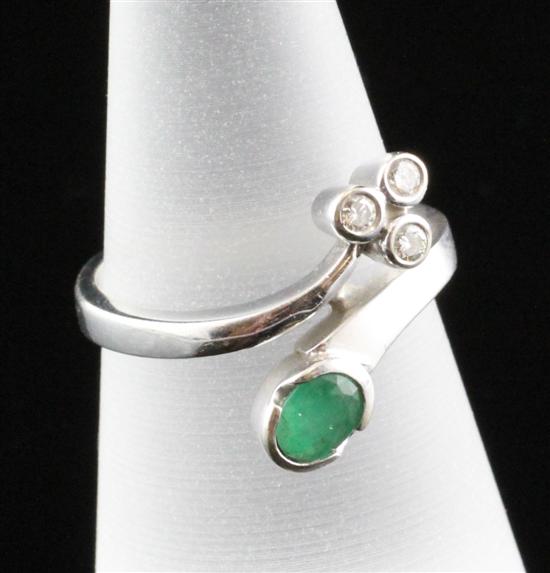 An 18ct white gold emerald and