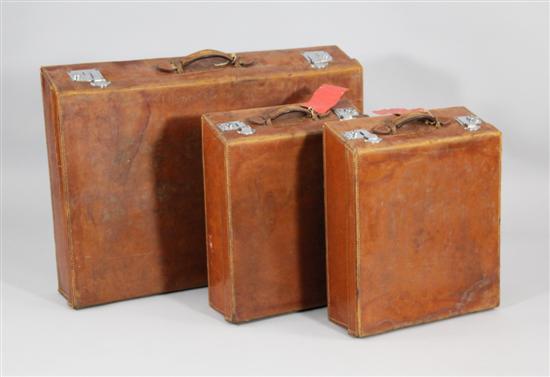 Three tan leather automobile cases