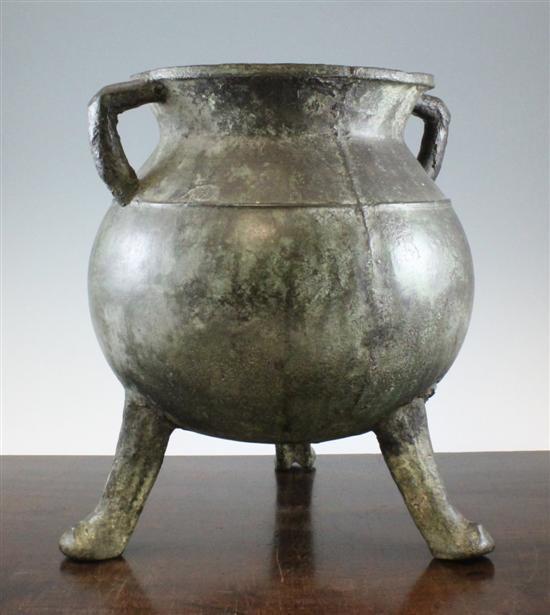 A large bronze cauldron on three