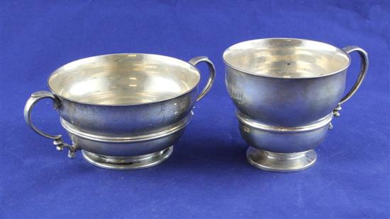 A George V silver mug and two handled